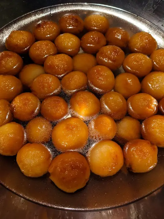 Rich Golden Gulab Jamuns in Saffron Rose Syrup
